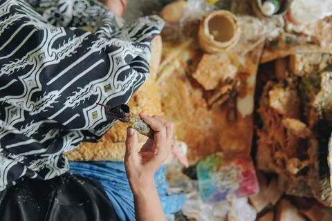 Top view of a person's hand drawing the design pattern of Indonesian batik .. Stock Photos