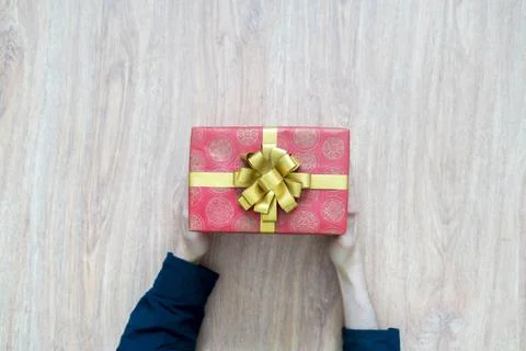 A top view of person's hands hold the holiday present gift box Stock Photos