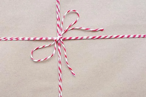 Top view photo of String or tied in bow on brown paper packaging. white and red  Stock Photos