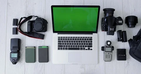 Top View of a Photographer Hand Processing Photos on Laptop With Green Screen Stock Footage 127703472