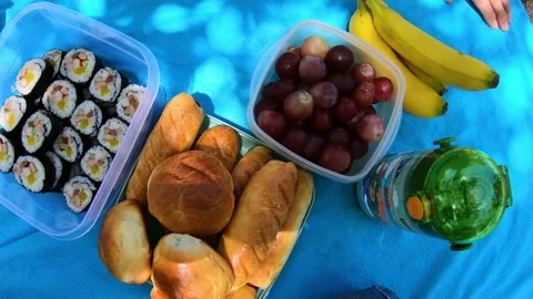 Top view of a picnic with fruits, Korean rolls and buns. Stock Footage