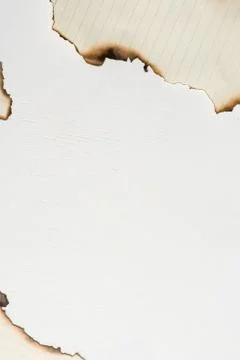 Top view of pieces of empty writing paper sheet with burned edges Stock Photos