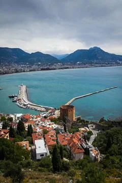 Top view of a pier with a red brick fortress tower with a beautiful white lig Stock Photos