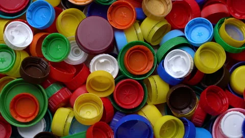 Top view pile of waste from plastic caps. Rotating background of garbage plastic Stock Footage 203919997