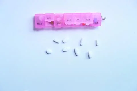 Top view of pill box and pills on white background Stock Photos