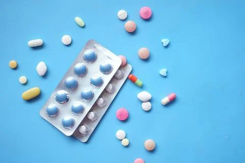 Top view of pills of blister pack on blue background Stock Photos