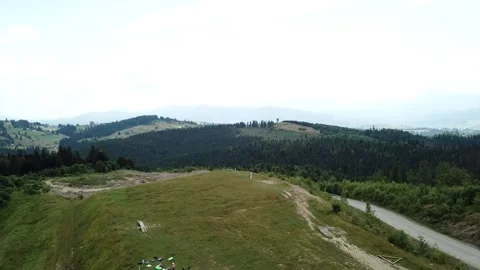 Top view of a pine forest in front of the Carpathian mountains, from drone Видео 135743355