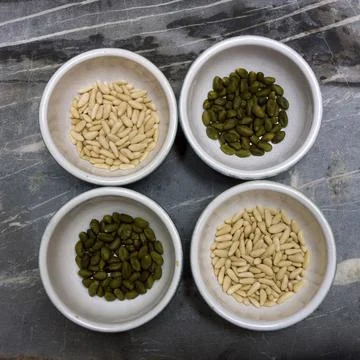Top view of pine nut and pistachios in bowls Stock Photos