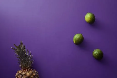 Top view pineapple limes violet Stock Photos