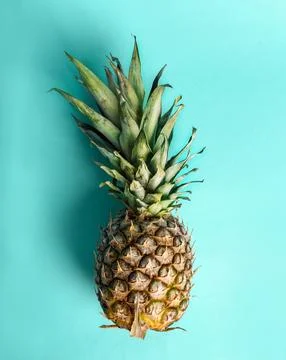 Top view of pineapple on retro bright blue background. Stock Photos