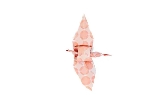 Top view pink circle pattern folded paper in crane shape, white background Foto stock