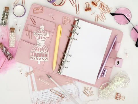 Top view of a pink planner with cute stationery. Pink glamour planner with a Illustrazione stock