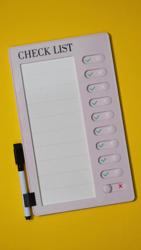 Top view of pink plastic checklist with yes no switch. Stop motion Video stock 283263479