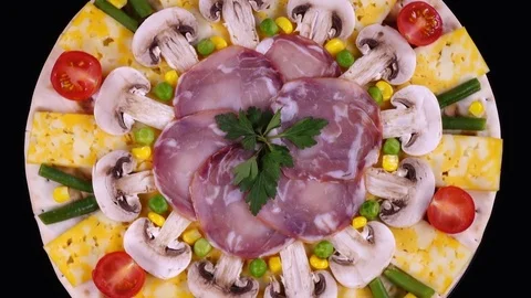 Top view of pizza before baking close up, rotating clockwise on black background Stock-Footage 84113702