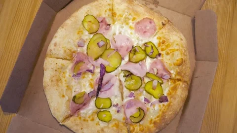 А top view of a pizza lying in a box on a table. Stock Footage 301713638