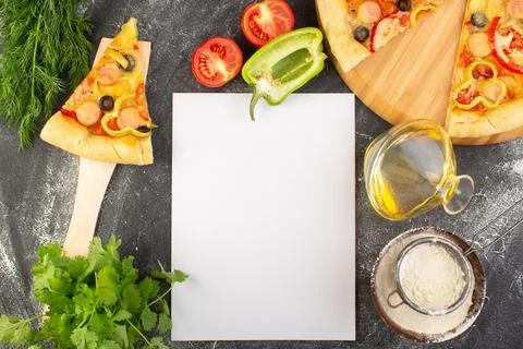 Top view pizza slice with black olives tomatoes and sausages along with gre.. Stock Photos