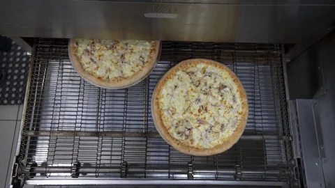 Top view of pizzas baking while coming out of oven 動画素材 121518637