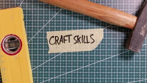 Top view of placing CRAFT SKILLS tape label on green grid mat. Stock Footage 337816292