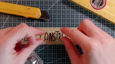 Top view of placing UNDER CONSTRUCTION tape near scraper tool. Stock Footage 337816306
