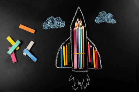 Top view, plane made of colored pencils with crayons on black background Stock Photos