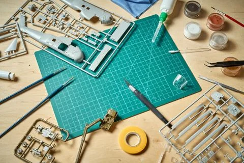 Top view on plastic model scale with accessories on  green pad on  wooden table Stock Photos