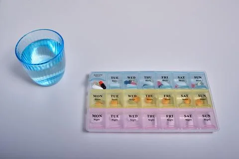 Top view of a plastic multi-colored convenient organizer for taking pills (vi Stock Photos