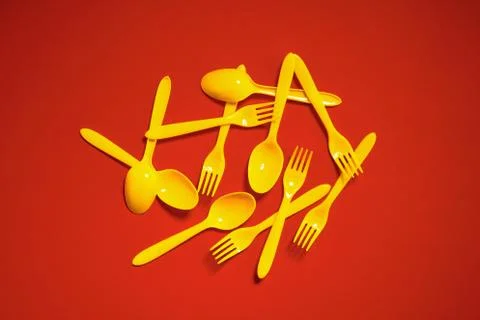 Top view of plastic spoons and forks pile Stock Photos