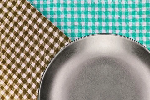Top view plate on checkered tablecloth pattern background Stock Photos