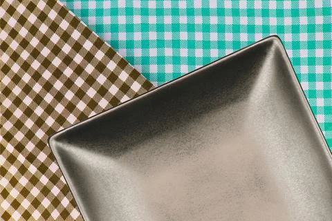 Top view plate on checkered tablecloth pattern background Stock Photos