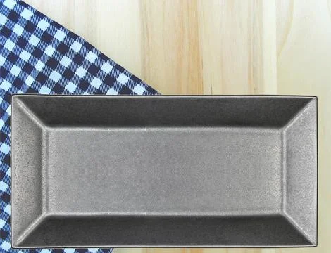 Top view plate on checkered tablecloth pattern background Stock Photos
