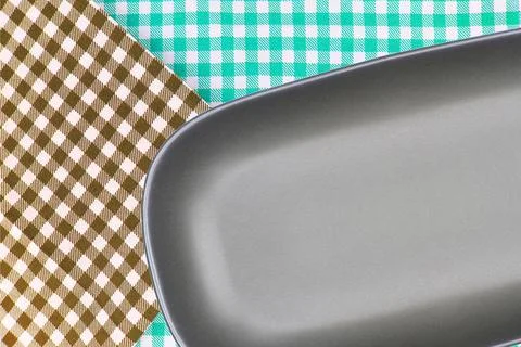 Top view plate on checkered tablecloth pattern background Stock Photos