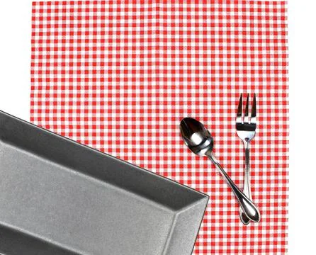 Top view plate with fork and spoon on tablecloth for food serving background Foto stock