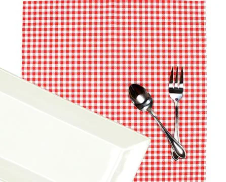 Top view plate with fork and spoon on tablecloth for food serving background Stock Photos