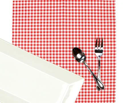Top view plate with fork and spoon on tablecloth for food serving background Stock Photos