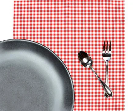 Top view plate with fork and spoon on tablecloth for food serving background Stock Photos