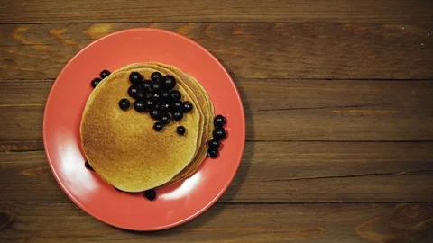 Top view of plate with pancakes and berries on wooden table, dolly shot. Stock Footage 102216679