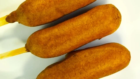 Top view of plate with three corn dogs spinning Stock Footage 78686046