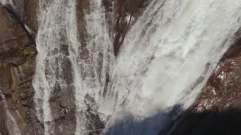 Top View Of Plunges Over Steep Rock Granite Cliff. Ezaro Waterfall Stock Footage 328403925