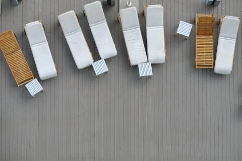 Top view pool bed, beach chair on wooden plank floor Stock Photos