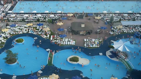 Top view of the pools with blue water and swimming people. Stock Footage 95776845