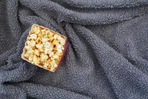 Top view of popcorn box on fluffy blanket Stock Photos