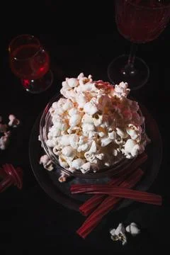 Top View of Popcorn, Red Drinks, and Licorice for a Movie Night Stock Photos