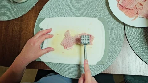 Top View Of Pork Cutlet Being Tenderized On Cutting Board Before Cooking Stock Footage 340890400