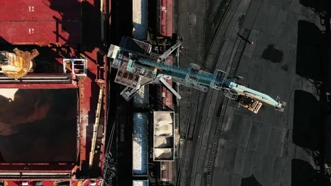 Top view of a port crane unloading a ship and a passing train in the seaport Video stock 236687106