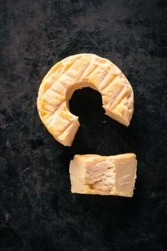 Top view on portion cut from whole golden camembert cheese Stock Photos