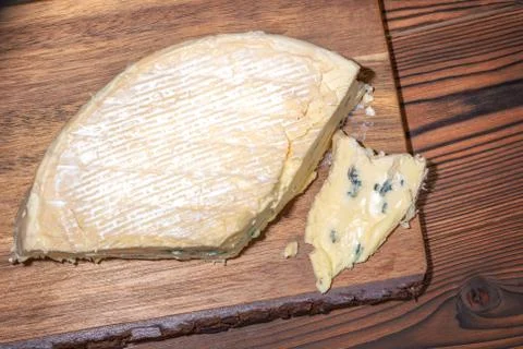 Top view of portion fresh blue cheese with mold on wooden texture, dairy prod Stock Photos