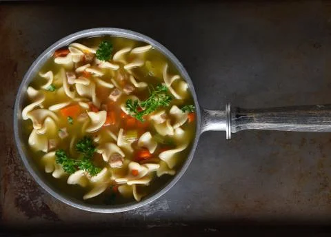 Top view of a pot of fresh homemade, Chicken Noodle Soup. Stock Photos