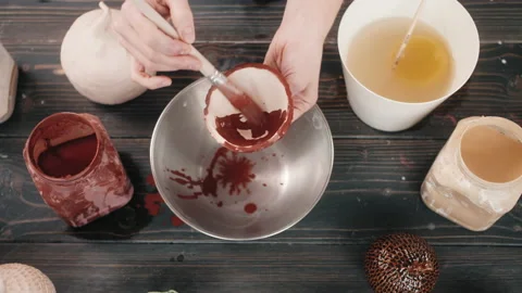 Top view potter making ceramic bowls and plates, woman hands painting color Stock Footage 143267447
