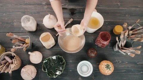 Top view potter making ceramic bowls and plates, woman hands painting color Stock Footage 147617365