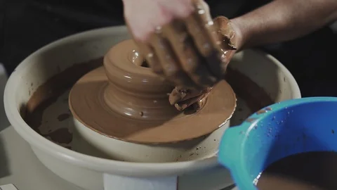 Top view on potter's hands work with clay. Potter shapes clay product Stock Footage 111754247